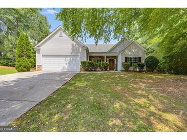 Charming single Gathering home with a well-manicured lawn and traditional white siding at 305 Overland Trl, Temple, GA 30179