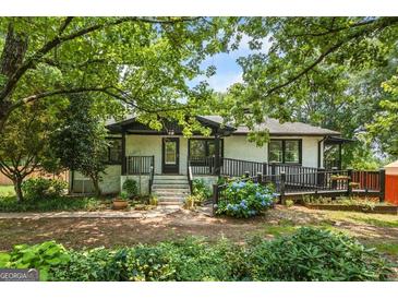 Charming single-Gathering home featuring mature landscaping and a welcoming front porch at 98 Maddox Dr, Mcdonough, GA 30252