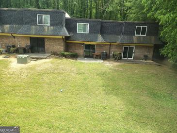 Townhome exterior with a large backyard and a quaint patio area for outdoor enjoyment at 187 Peyton Sw Pl, Atlanta, GA 30311