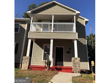 Charming two-story home featuring a cozy balcony and inviting front entrance at 821 Beckwith Sw St, Atlanta, GA 30314