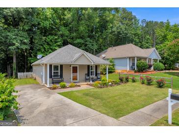 Charming single-story home with a well-manicured lawn and inviting front porch at 136 Glynn Addy Dr, Stockbridge, GA 30281