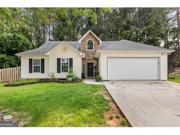 Charming single-story home with a two-car garage and manicured front lawn at 11765 Fairway Overlook, Fayetteville, GA 30215