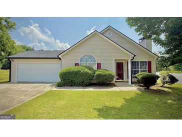 Charming single Gathering home with a well-maintained lawn, attached garage, and manicured landscaping at 6638 Creek Turn Dr, Rex, GA 30273