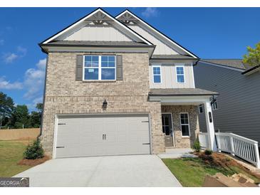 New construction two-story home featuring a two-car garage, gray brick, and gray vinyl siding at 35 Fraser Ln # 123B, Auburn, GA 30011