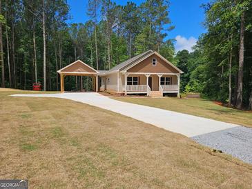 Charming single-story home featuring a welcoming front porch, carport, and a well-maintained yard with beautiful curb appeal at 55 Etheridge Rd, Temple, GA 30179