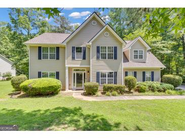 Charming two-story home featuring a well-manicured lawn and classic shutters at 15 Skipton Ct, Sharpsburg, GA 30277