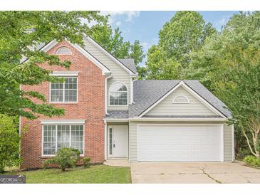 Charming two-story home featuring brick accents, a two-car garage, and a well-maintained front lawn at 2576 Abbotts Glen Nw Dr, Acworth, GA 30101