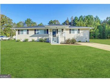 Charming single-story home with a well-manicured lawn, inviting front porch, and freshly painted trim at 64 Gregory Ct, Dallas, GA 30157