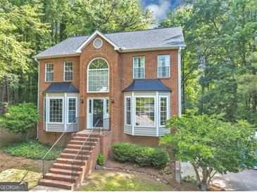 Charming two-story brick home with beautiful windows, black shutters and a landscaped front yard at 1625 Clark Lake Nw, Acworth, GA 30102