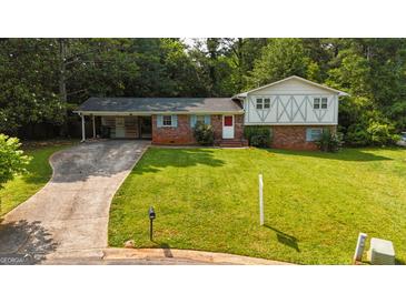 Charming two-story brick home with a well-manicured lawn and covered parking at 1486 Harbour Oaks Rd, Tucker, GA 30084