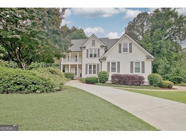 Charming two-story home with a well-manicured lawn and beautiful landscaping at 505 Lighthouse Ln, Peachtree City, GA 30269
