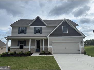Inviting two-story home featuring a neutral palette, attached two-car garage, and tastefully landscaped front yard at 500 Cantrell Drive, Dallas, GA 30157