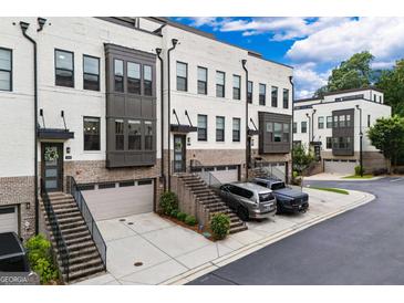 Beautiful townhomes showcase brick and painted exteriors, private garages, and inviting staircases at 2118 Iverson Se Dr, Smyrna, GA 30080