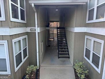 Building exterior featuring stairs leading to the units and well-maintained landscaping at 5147 Roswell Rd # 47, Atlanta, GA 30342