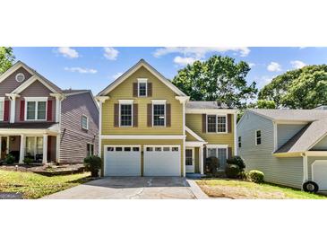Charming two-story home with an attached two car garage, and complementary landscaping at 984 Wenham Ln, Lawrenceville, GA 30044