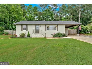 Charming, renovated brick ranch on a lush lot with a carport, offering curb appeal and ample space at 30 Mary Ella Dr, Carrollton, GA 30116
