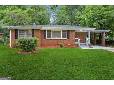 Charming brick home with a well-maintained lawn, covered carport, and traditional windows at 2858 Valley Ridge Dr, Decatur, GA 30032