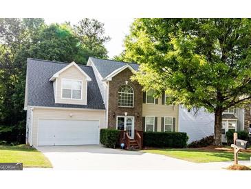 Charming two-story home with brick facade, attached garage, and well-maintained landscaping at 149 Titan Rd, Stockbridge, GA 30281