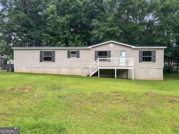 Charming single-story home featuring a well-maintained lawn and cozy front porch, perfect for relaxed living at 368 Hemlock Ln, Locust Grove, GA 30248