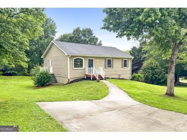 Charming single-story home featuring a well-manicured lawn and inviting front walkway at 1432 Almand Creek Drive Sw, Conyers, GA 30094