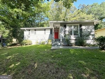 Charming single story home with a well-maintained front yard and inviting red front door at 1991 Turner Se Rd, Atlanta, GA 30315