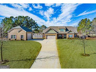 Beautiful home with lush landscaping and a detached garage, offering plenty of space and curb appeal at 125 Kayla Ct, Locust Grove, GA 30248