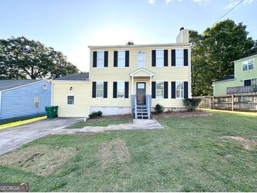 Inviting two-story home with a well-maintained lawn and classic black shutters at 4320 Catalpa Way, Ellenwood, GA 30294