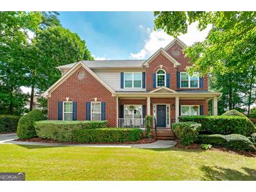Beautiful two-story brick home with manicured lawn and charming front porch at 1120 Bagwell Dr, Kennesaw, GA 30152