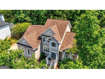 Stunning traditional-style home with a well-maintained brown roof and lush green landscaping at 306 Sandalin Ln, Peachtree City, GA 30269