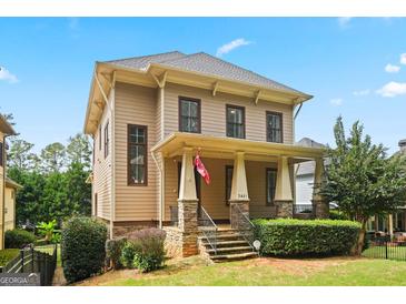 Charming two-story home featuring a welcoming front porch with stone accents and well-manicured landscaping at 3451 Fairway Dr, College Park, GA 30337