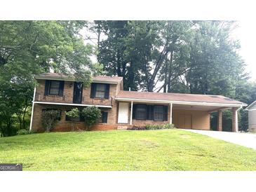 Two-story brick home with a covered carport and a well-maintained front lawn at 4196 Lehigh Blvd, Decatur, GA 30034