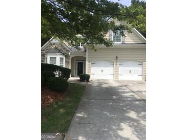 Charming home featuring a stone facade, a two-car garage, and a well-manicured lawn at 1697 Preserve Park Dr, Loganville, GA 30052