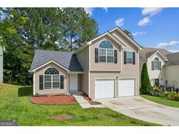 Charming two-story home with a two-car garage, lush lawn, and inviting curb appeal at 2635 Carolina Rdg, Riverdale, GA 30296