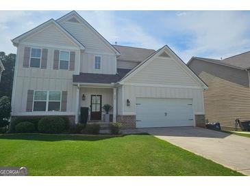 Charming two-story home features a two-car garage and a well-manicured lawn, offering excellent curb appeal at 236 Villa Grande Dr, Locust Grove, GA 30248