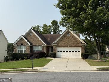 Charming brick home with a well-manicured lawn and a two-car garage at 1717 Prospect View Dr, Lawrenceville, GA 30043