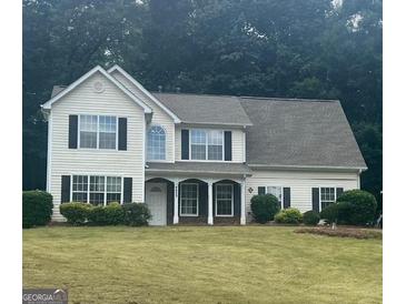 Charming two-story home with a well-manicured lawn and traditional architectural details at 4489 Northwind Dr, Ellenwood, GA 30294
