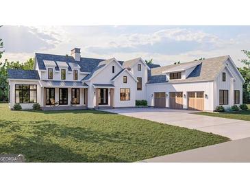 Beautiful modern farmhouse with a well-manicured lawn and a three-car garage at 120 Godby Dr, Fayetteville, GA 30215