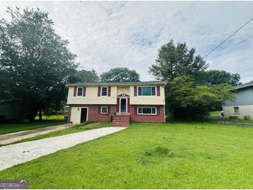 Charming two-story home with a well-maintained lawn and inviting entryway at 1766 Tilden Ave, Jonesboro, GA 30236
