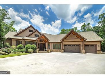 Stunning home with three-car garage, stone accents, and professional landscaping creates an inviting curb appeal at 177 Selfridge Rd, Mcdonough, GA 30252
