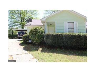 Charming home with a well-maintained lawn and a convenient carport at 905 Ohara Dr, Jonesboro, GA 30236