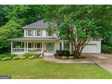 Charming two-story home with a welcoming front porch and beautifully landscaped front yard at 4645 Villa Ridge Ne Rd, Marietta, GA 30068