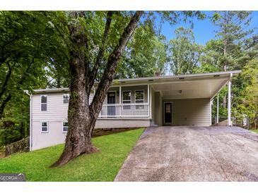 Charming single-Gathering home featuring a spacious carport, inviting front porch, and well-maintained landscaping at 64 Acorn Dr, Dallas, GA 30157
