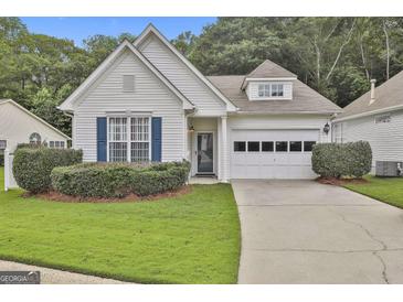 Charming one-story home features a well-manicured lawn, garage and beautiful shutters at 2118 Cherry Tree Ln, Peachtree City, GA 30269