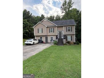 Inviting two-story home with neutral siding, well-maintained lawn, and paved driveway, perfect for suburban living at 120 Alfred Dr, Carrollton, GA 30116