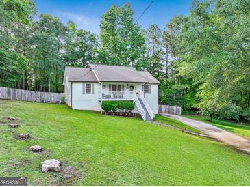 Charming, well-maintained home with a lovely front yard, inviting curb appeal, and a delightful covered porch at 394 Thornbrooke Dr, Hiram, GA 30141