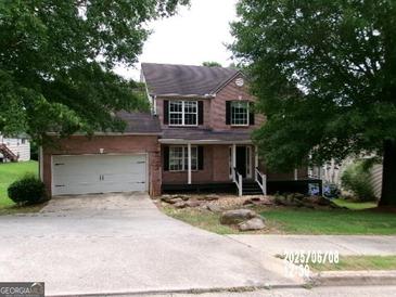 Charming two-story brick home with a front-facing garage and landscaped yard at 2225 Blue Ridge Ln, Conyers, GA 30012