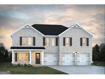 Charming two-story home featuring a brick facade, complemented by dark shutters and a spacious three-car garage at 1662 Fuma Leaf Way # 308, Mcdonough, GA 30253