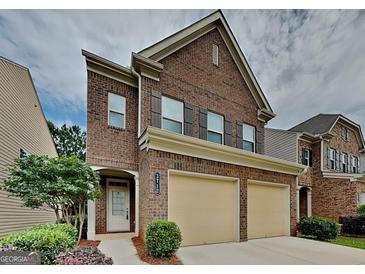 Charming two-story brick home featuring a two-car garage and well-maintained landscaping at 3712 Upland Dr, Mcdonough, GA 30253