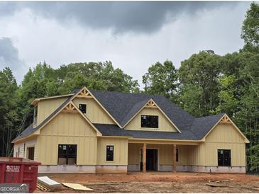 Charming new home featuring a craftsman-style exterior with yellow siding and black windows at 365 Spruill Bridge Road # 7 - Helmsley Park, Temple, GA 30179