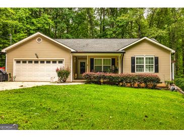Charming single-story home with a well-maintained lawn, attached garage, and flowering bushes at 107 Trisha Ln, Grantville, GA 30220